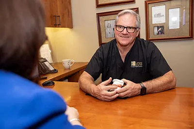 Dr. Brock Lynn of Lynn Dental Care talking with a patient about dental care