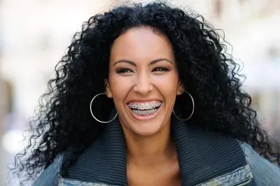 older woman with braces smiling