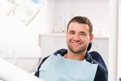 man smiling in the dental chair at Lynn Dental Care