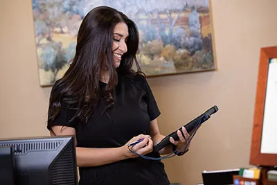 front desk coordinator scheduling a patient's next dental appointment at Lynn Dental Care