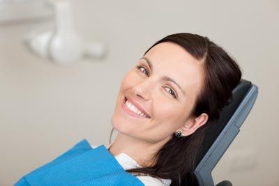 patient smiling while sitting in the dental chair at Lynn Dental Care