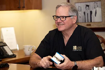 Dr. Brock Lynn of Lynn Dental Care explaining to a patient how sleep apnea treatment can help them sleep better at night