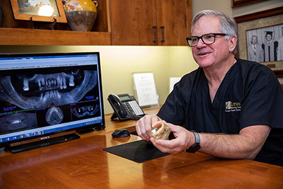 Dr. Brock Lynn of Lynn Dental Care in Dallas, TX explaining how restorative dentistry can help a patient's smile