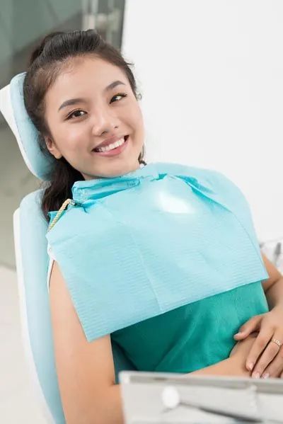 patient smiling after getting her old fillings removed