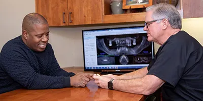 Dr. Lynn talking with a patient about his dental x-rays